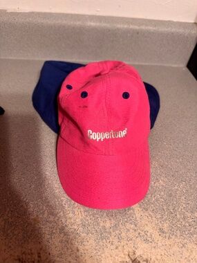 Coppertone brand sun protection hat, featuring a pink cap with a blue neck flap.